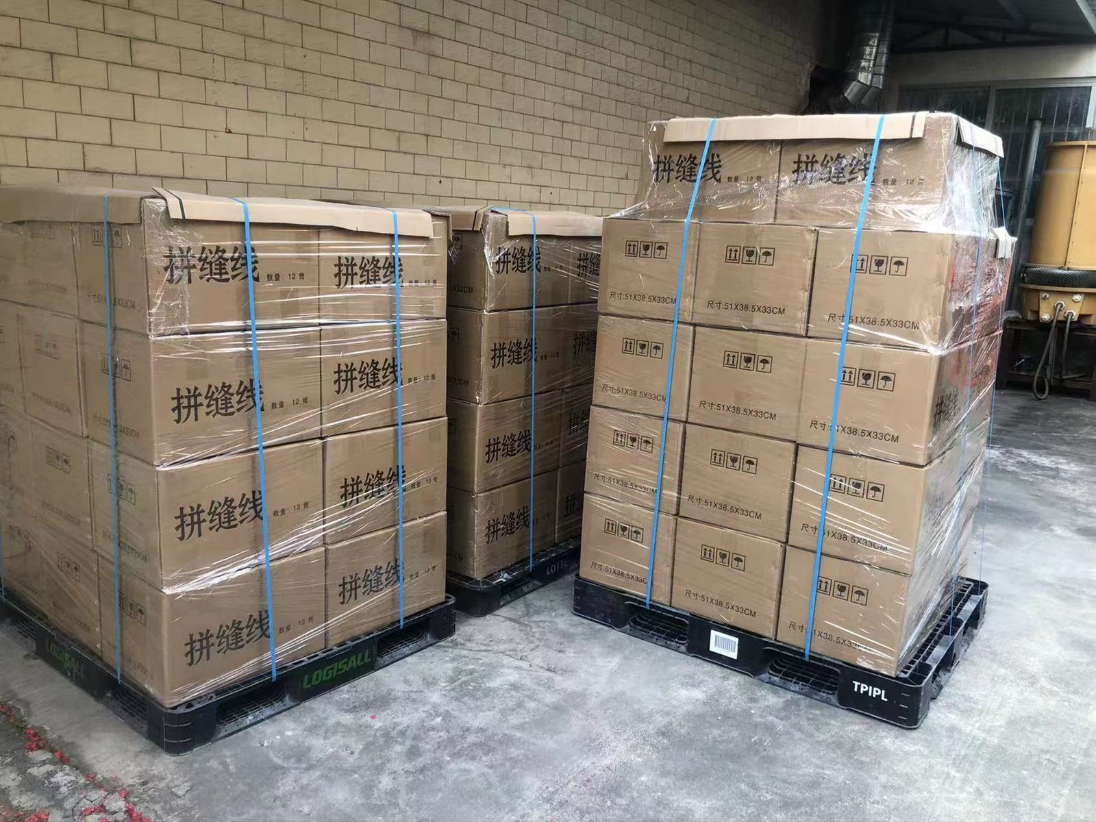 Palletized cartons of veneer splicing thread prepared for shipment